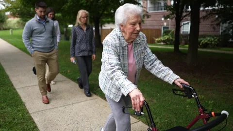 Slow motion closeup of elderly senior old woman using walker for mobility on Stock Footage 253404690