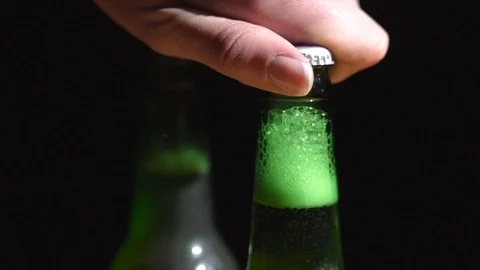 Slow motion closeup hand twists off beer cap Stock Footage 126018724