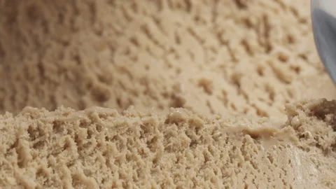 Slow motion closeup hazelnut praline ice cream scooping with spoon Stock Footage 138251445