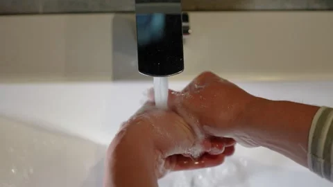 Slow Motion. Closeup of Human Hand Under Stream of Pure Water From Tap. Stock Footage 247794497