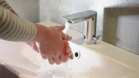 Slow Motion. Closeup of Human Hand Under Stream of Pure Water From Tap. Stock Footage 247794520