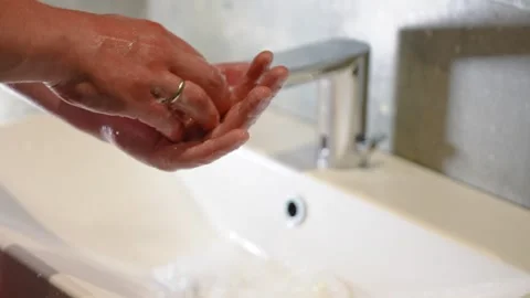 Slow Motion. Closeup of Human Hand Under Stream of Pure Water From Tap. Stock Footage 247794565