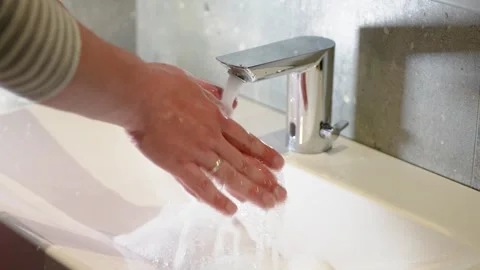Slow Motion. Closeup of Human Hand Under Stream of Pure Water From Tap. Stock Footage 247794603