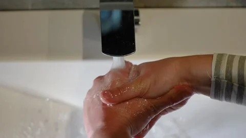 Slow Motion. Closeup of Human Hand Under Stream of Pure Water From Tap. Stock Footage 247794633