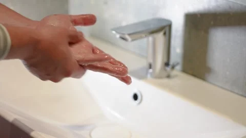 Slow Motion. Closeup of Human Hand Under Stream of Pure Water From Tap. Stock Footage 247794653