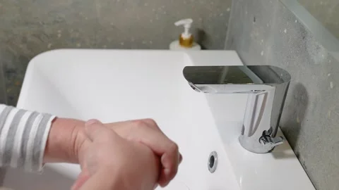 Slow Motion. Closeup of Human Hand Under Stream of Pure Water From Tap. Stock Footage 247794764