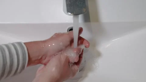 Slow Motion. Closeup of Human Hand Under Stream of Pure Water From Tap. Stock Footage 247794807