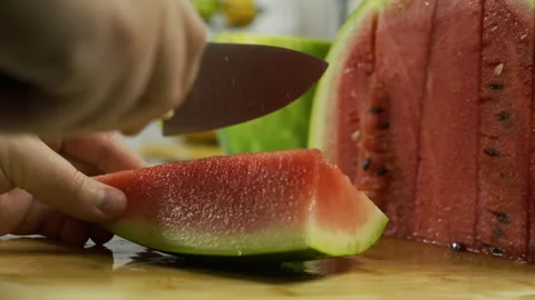 Slow motion closeup of knife cutting through watermelon slice Stock Footage 341201792