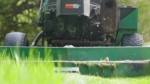 Slow motion Closeup: Large professional Lawnmower cuts grass on summer lawn Stock Footage 153287838