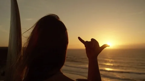 SLOW MOTION CLOSEUP Long haired female surfer gesturing hang loose with her hand Stock Footage 85292733
