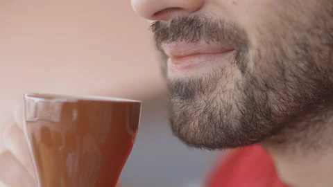 Slow motion: Closeup of man that drinks an Espresso coffee, then smiles Stock Footage 148202705