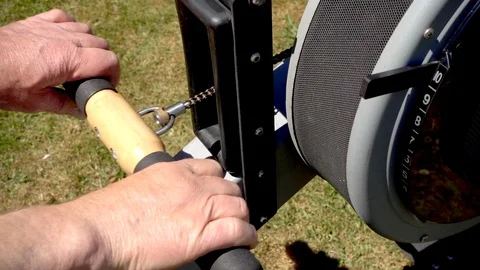 Slow motion: Closeup of a man using a rowing machine outside. Stock Footage 91290738