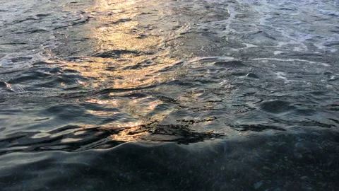 Slow motion: closeup of ocean wave with sunset light reflection. Dusk light Stock Footage 138225887