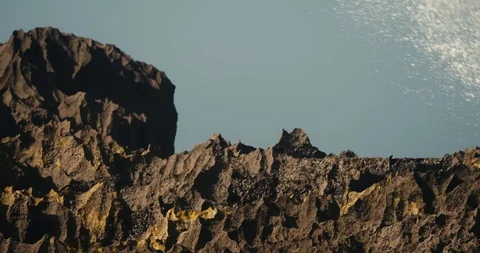 Slow motion closeup of ocean waves exploding on rocky shores in a tropical Stock Footage 126884042