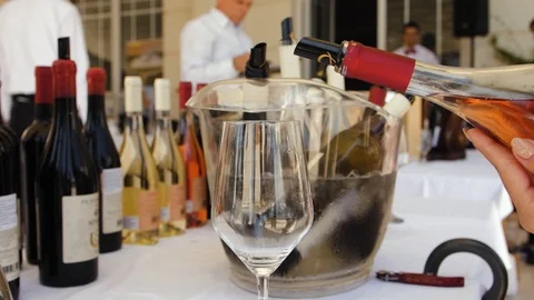 Slow motion closeup of rose wine pouring into crystal glass Stock Footage 119392285