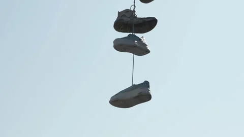 Slow Motion Closeup of Shoes on String in Shoreditch Stock Footage 307932357