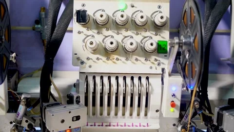 Slow motion closeup shot of automatic embroidery machine with multiple heads Stock Footage 199271410