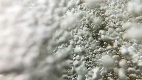 Slow-motion closeup shot of a clear water stream in slight downfall into a pool Video stock 248073398