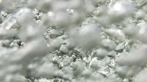 Slow-motion closeup shot of a clear water stream in slight downfall into a pool Stock Footage 248379903