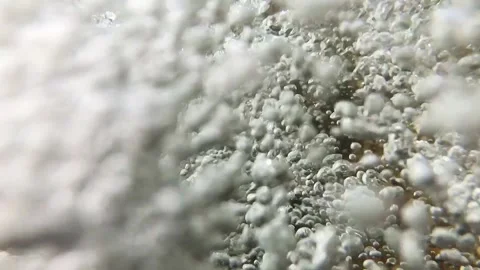 Slow-motion closeup shot of a clear water stream in slight downfall into a pool Stock Footage 248380797