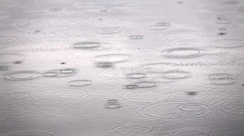 Slow motion closeup shot of light rain on the water surface 動画素材 64587452