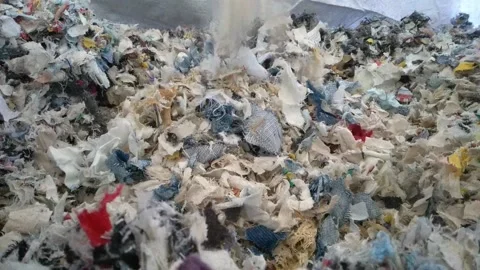 Slow motion Closeup Shredded Textile residue falling to a big bag. Concept Stock Footage 211502606