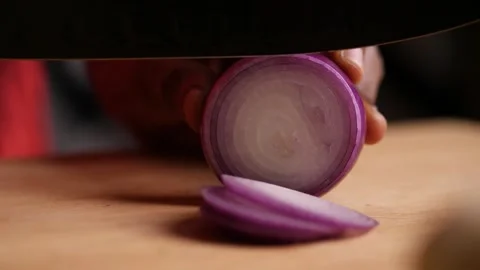 Slow motion closeup sliding shot of a onion being chopped Stock Footage 136653326