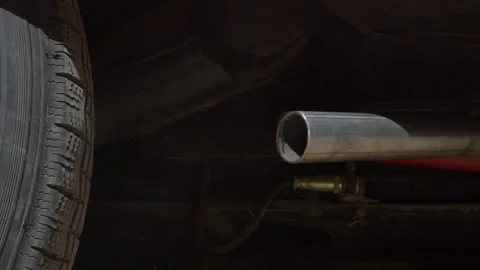 Slow motion closeup of thick white smoke billowing from a car exhaust pipe Stock Footage 309240050