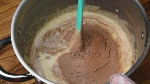 A slow-motion closeup video of a pastry chef preparing a chocolate mousse Video stock 154011759