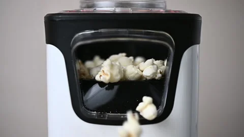 Slow motion closeup video of popcorn maker popping popcorn Stock Footage 167922105