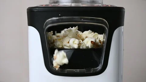 Slow motion closeup video of popcorn maker popping popcorn Stock Footage 167922134