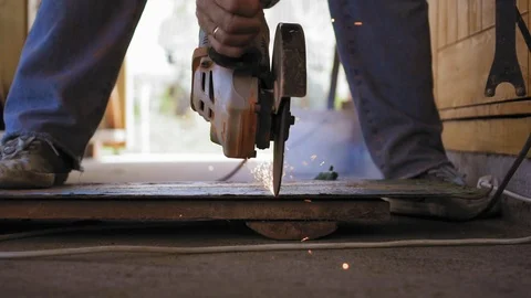 Slow motion closeup view of a grind disk is sawing the metal and sparks are Stock Footage 90430330