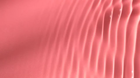 Slow motion closeup water surface texture splash and ripples on pink background Stock Footage 169131303