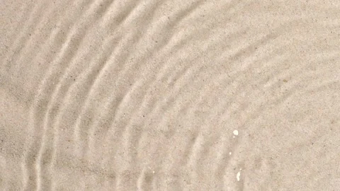 Slow motion closeup water surface texture splash and ripples on sand background 스톡 동영상 169426744