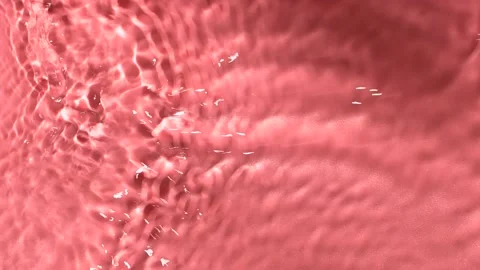 Slow motion closeup water surface texture splash and ripples on pink background Stock Footage 171364016