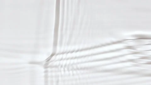 Slow motion closeup water surface texture splash and ripples on white background Stock Footage 197052570