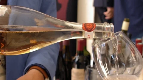 Slow motion closeup of white wine pouring into crystal glass Stock Footage 119392368