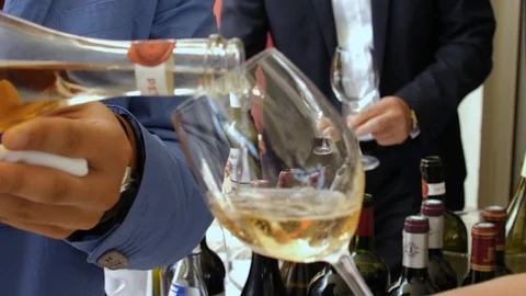 Slow motion closeup of white wine pouring into crystal glass Stock Footage 119392471