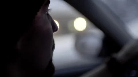 Slow Motion Closeup Of Young Man Driving On A Snowy Winter Night Stock Footage 71997387
