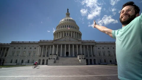 Slow motion closeup of young man turning with arms in the air and laughing for Stock Footage 128717730