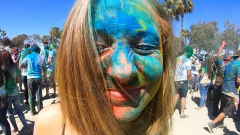Slow motion of closeups of people's faces covered in paint, color holi festival Stock Footage 135317671