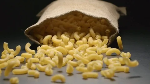 SLOW MOTION: Cloth bag falls and pasta fall out of him Stock Footage 72496027