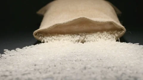 SLOW MOTION: Cloth bag falls and white rice fall out of him Stock Footage 72496068