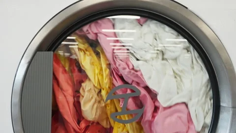 Slow motion of clothes being dried in the dryers at a local laundromat Stock Footage 248859498