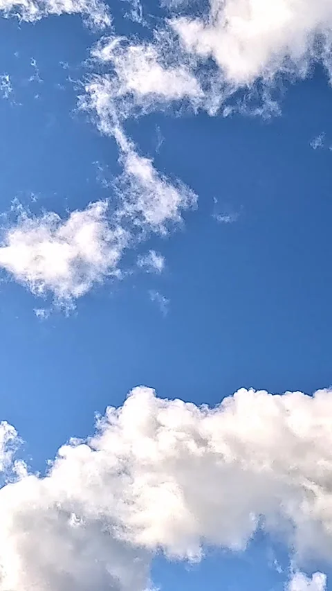 Slow motion clouds moving across bright blue summer sky Stock Footage 318007080