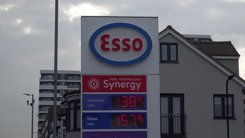 In Slow Motion Clouds Pass An Esso Petrol Station Billboard Listing Fuel Prices Stock Footage 332059901
