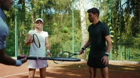 Slow motion coach teaching play tennis man and woman outdoor sports players Video stock 139579357