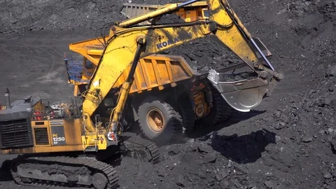 Slow motion of coal loading tip truck after filling excavator bucket Stock Footage 90491166