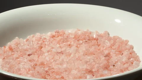 Slow Motion Coarse Pink Himalayan Salt Falling Into White Bowl Video stock 331854022