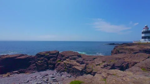 Slow motion coastal view of lighthouse under bright sunny sky Stock Footage 340454104